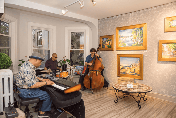 A three-man band plays in an art gallery in Lancaster City